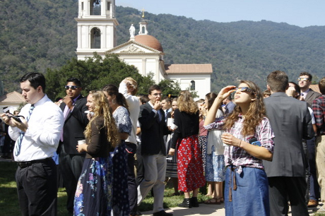  Members of the student body view the solar eclipse …
