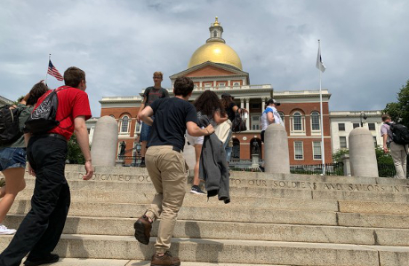 Students climb steps of State House