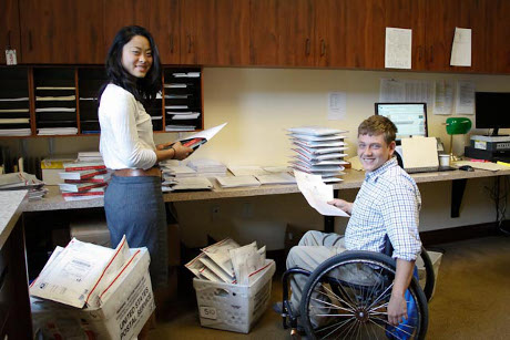 Admissions staff prepare the readings for mailing