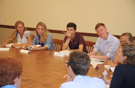 students engage in conversation around the table