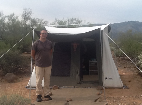 Mark Byerly poses outside his tent in Arizona