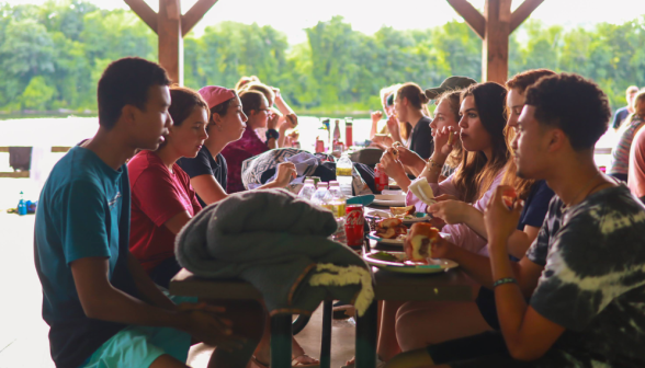 Students dine at the long picnic table