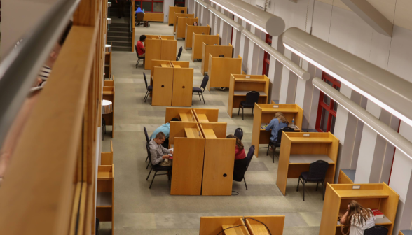 Students study at rows of individual desks