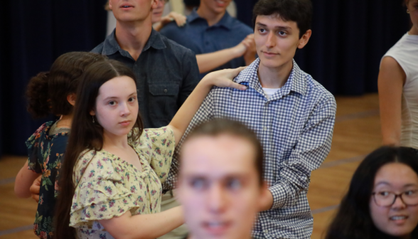 A student couple listens to instructions