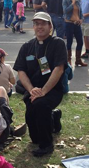 Rev. Ramon Decaen (’96) waits for the Popemobile to pass by in Philadelphia