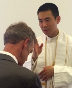 Fr. Jacob offers a blessing to Director of Gift Planning Tom Susanka