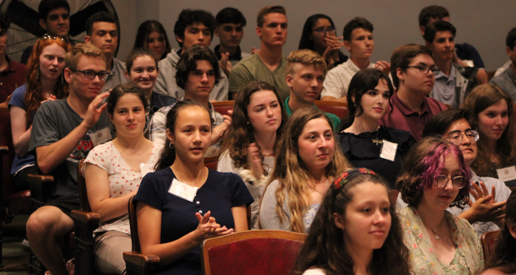 Students seated in the Auditorium applaud