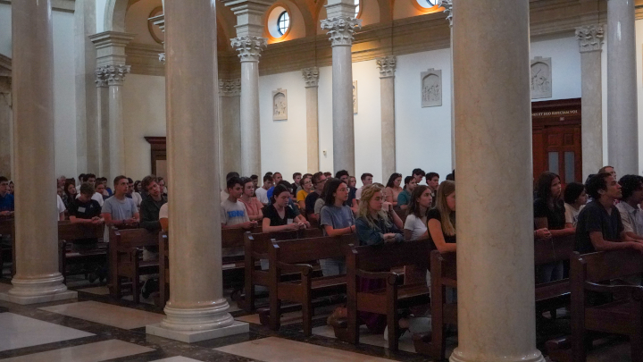 Students pack the Chapel, praying the Rosary