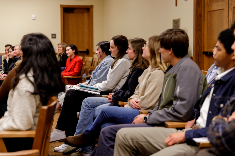 Students listen to a talk from Dr. Pia de Solenni (’93)