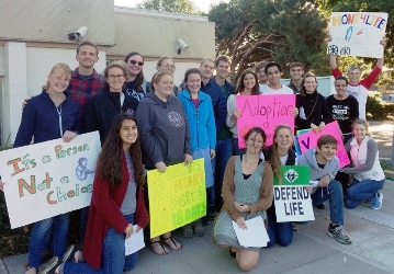 Students carol outside Planned Parenthood