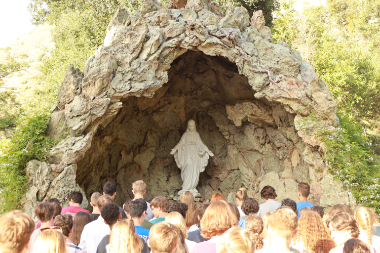 Students praying at Lourdes Grotto