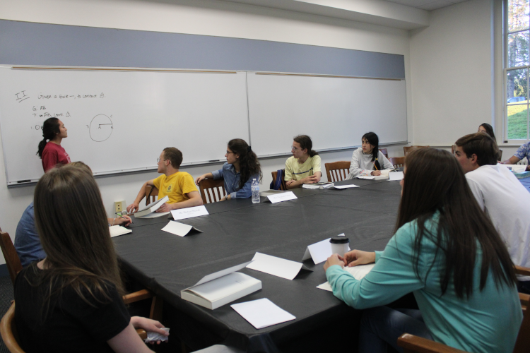 A prefect demonstrates a prop while students watch in one of the classrooms