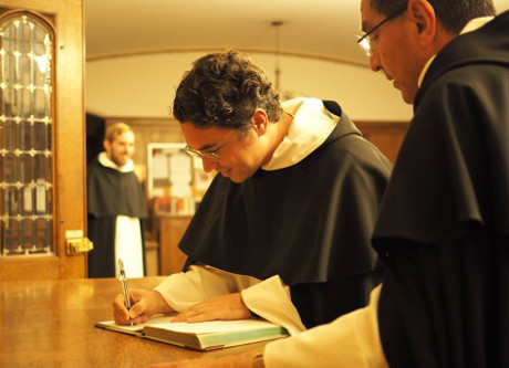 Br. Athanasius signs the Vestition book. (Photo: Western Dom
