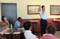Nathan Haggard (’99) speaks with students in the campus coff