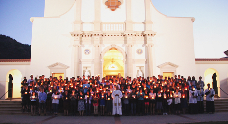 Students holding candles in the plaza of Our Lady of the Mos