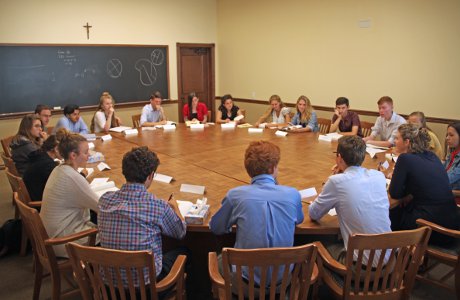 students engage in conversation around the table