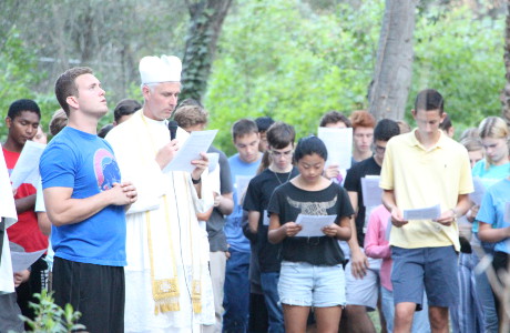 Fr. Sebastian leads students in the praying the Stations of 