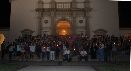 Students with candles standing in front of the Chapel
