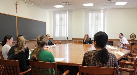 Clare Hoonhout (’08), RN, speaks to students at Thomas Aquin