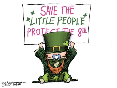 Leprechaun baby holds sign proclaiming, 
