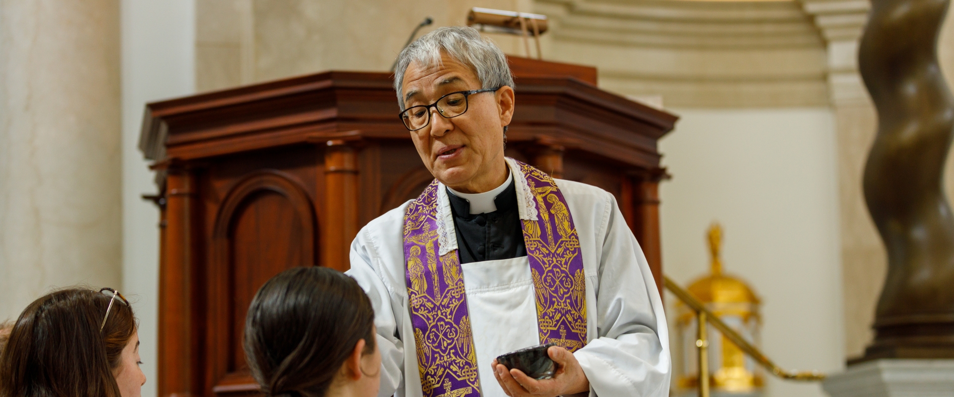 Fr. Chung imposes ashes on Ash Wednesday