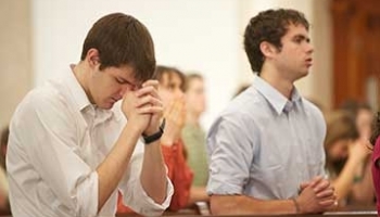 Students praying in Chapel