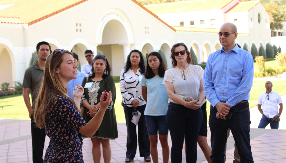 On the chapel steps, an admissions member leads a tour for a small group of HSSP family members