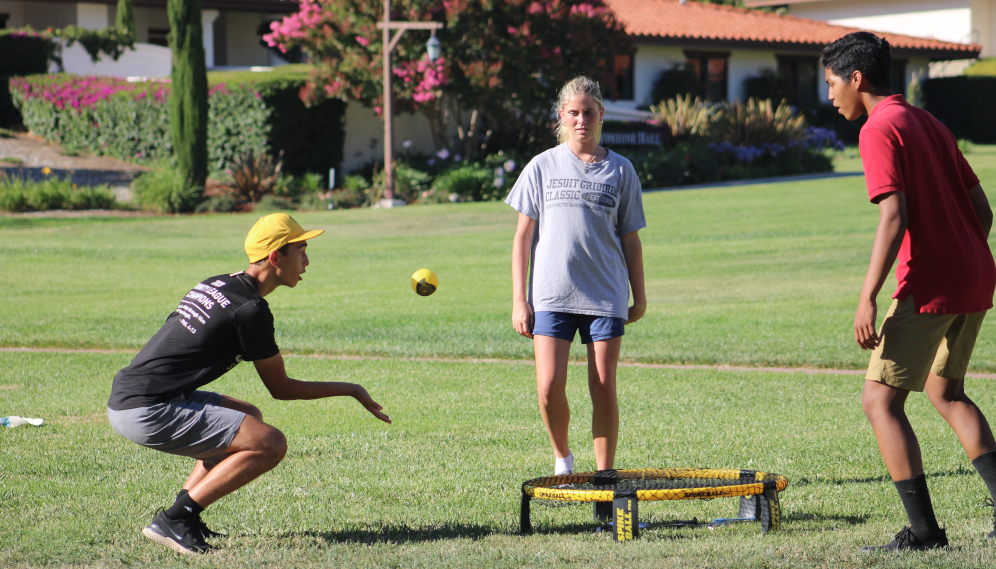 A game of Spikeball on the athletic field