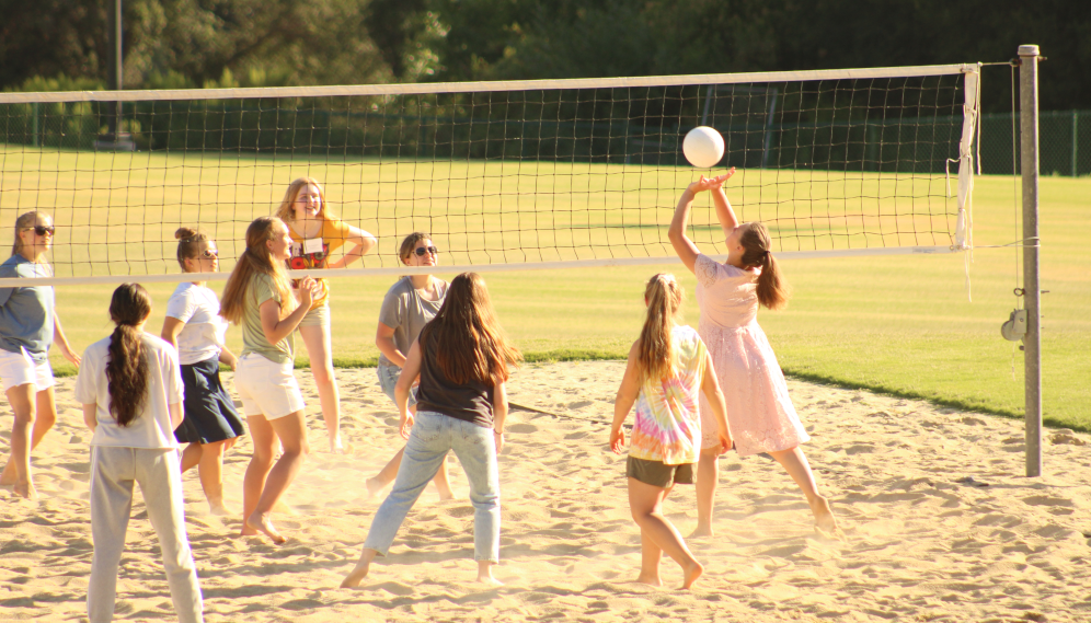 A game of volleyball on the sand court