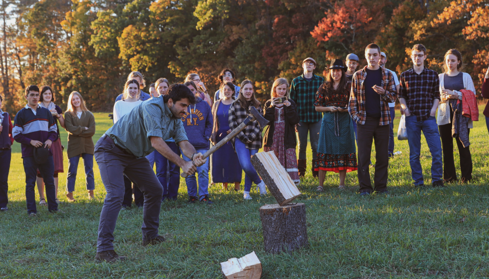 A student participates in the wood-chopping contest