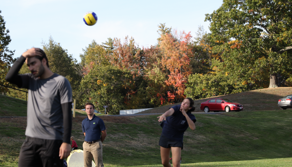 A student performs an overhand serve