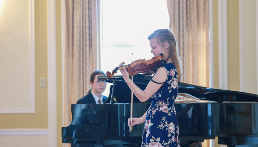 Two perform on the piano and violin
