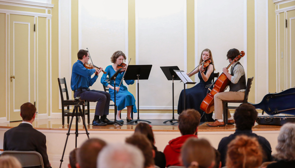 A zoomed-out view of the string quartet playing