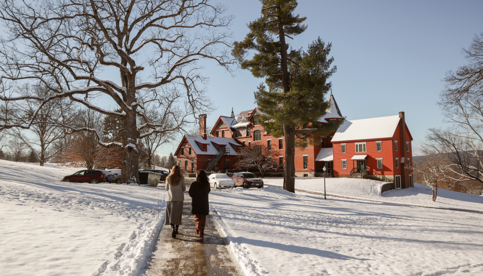 Two walk toward East Hall amid the snow
