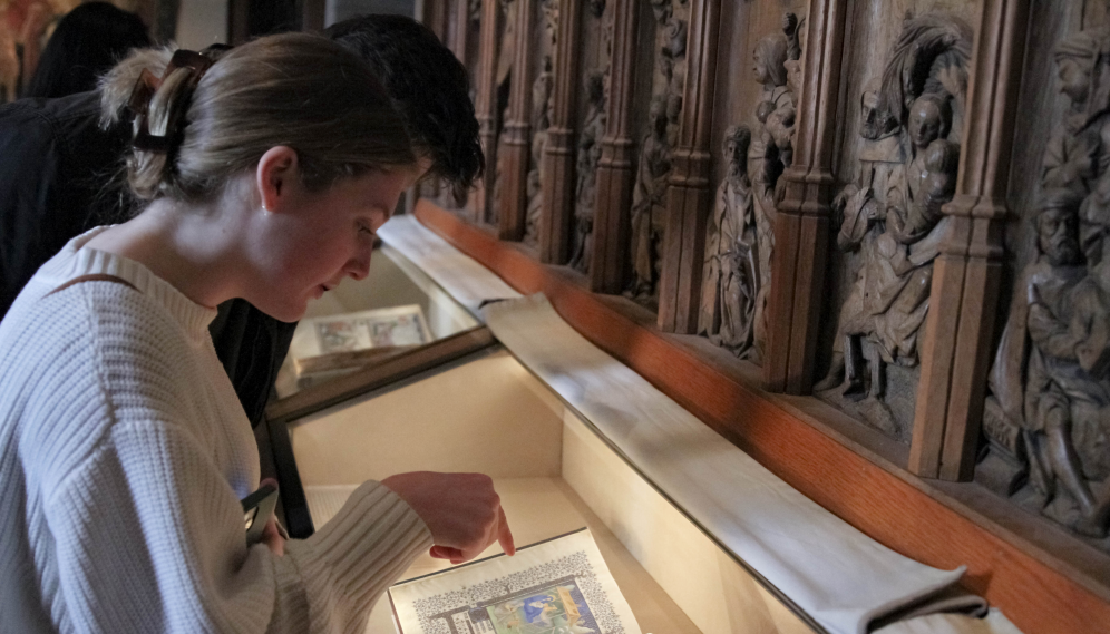 Students examine bound manuscripts