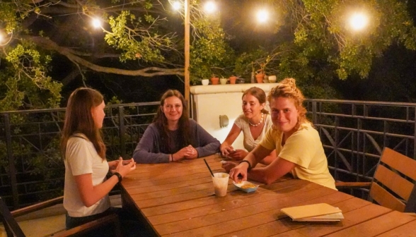 Students enjoy the evening outside on the coffee shop patio