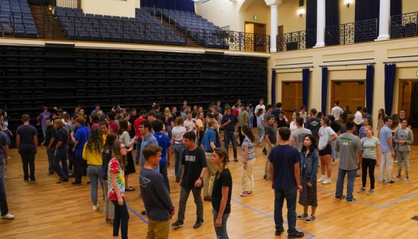 Students pair up to practice dancing, many for the first time