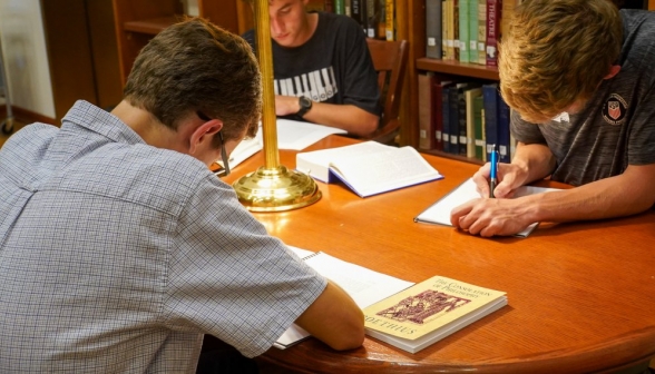 Close-up of students poring over readings