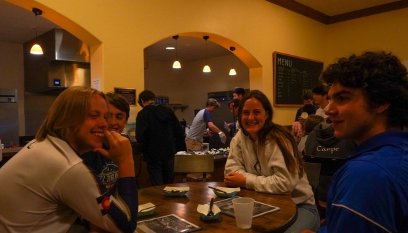 A group enjoys brownies and ice cream at one of the smaller side tables
