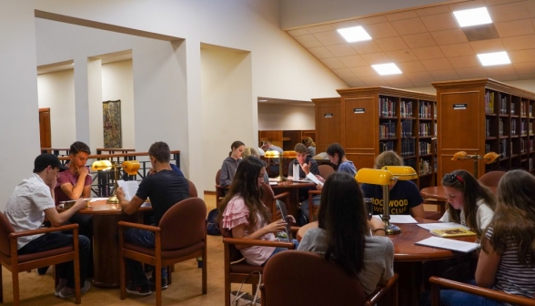 Students at the tables in the library's rear right wing