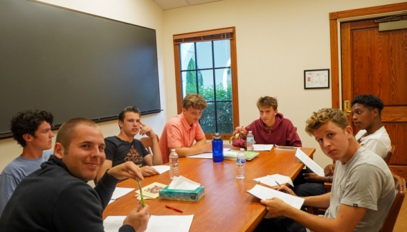 Seven students study in a study room