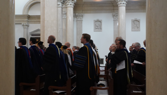 The faculty of the College fills their pews in full academic regalia
