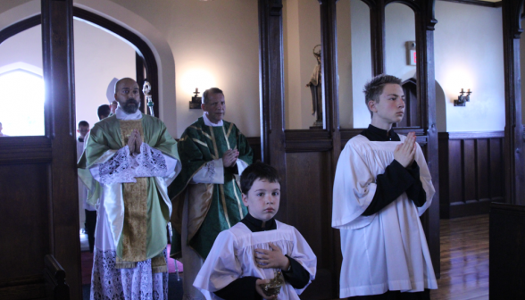Fr. Markey, Fr. Viego, and two altar servers in the procession