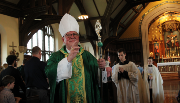 Walking out after Mass, Bishop Byrne blesses the congregation