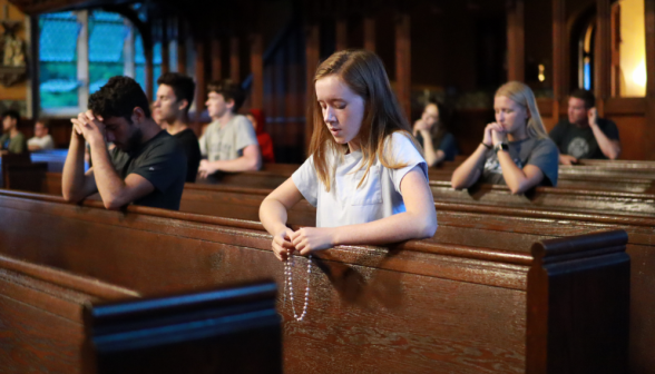 A student praying the Rosary