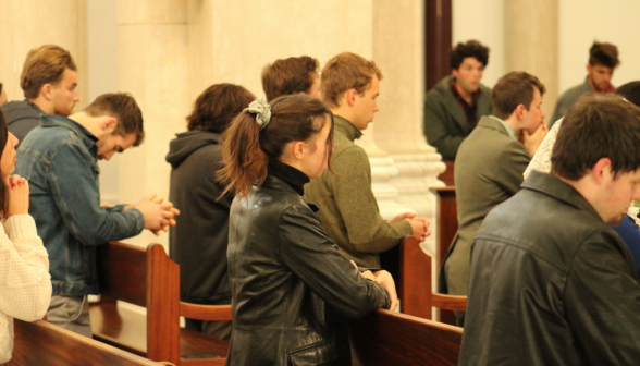 Students pray before finals in the Chapel