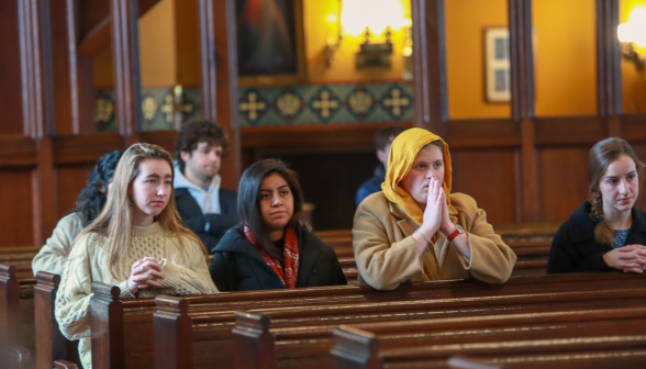 Students pray in the pews