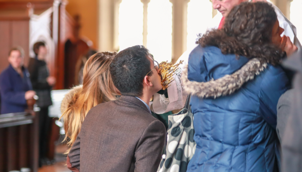 Students kiss the relic