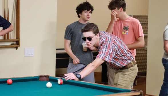 A student plays pool