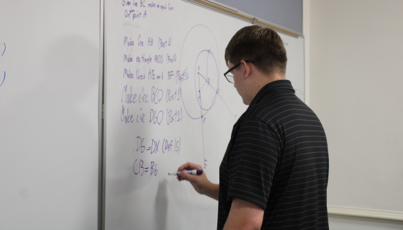 A student practices at the board
